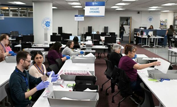 FILE - County employees open ballots in the mail ballot processing room at the Washoe County Registrar of Voters office in Reno, Nev., June 3, 2024. (AP Photo/Andy Barron, File)