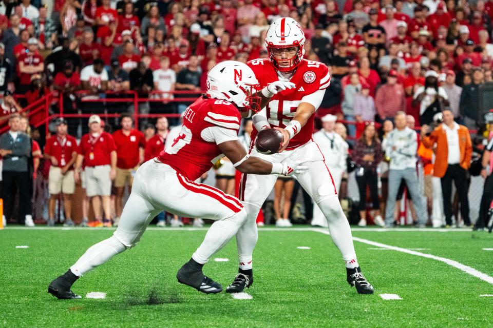 Sep 7, 2024; Lincoln, Nebraska, USA; Nebraska Cornhuskers quarterback Dylan Raiola (15) hands the ball off to running back Dante Dowdell (23) during the third quarter against the Colorado Buffaloes at Memorial Stadium. Mandatory Credit: Dylan Widger-Imagn Images