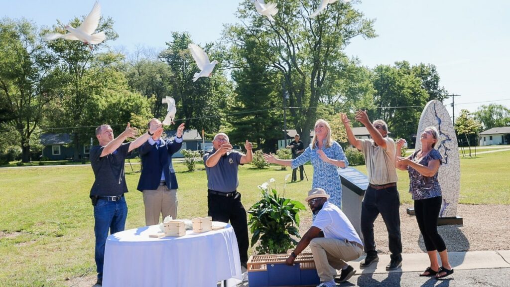 Fox Hollow memorial attendees release doves