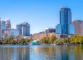 Glass buildings, condos, and offices line the shores of Lake Eola at the heart of Orlando, Fla.