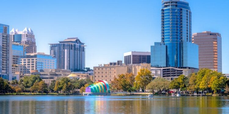 Glass buildings, condos, and offices line the shores of Lake Eola at the heart of Orlando, Fla.