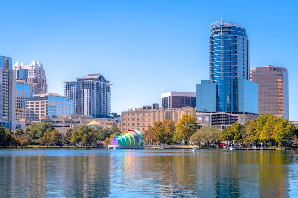 Glass buildings, condos, and offices line the shores of Lake Eola at the heart of Orlando, Fla.