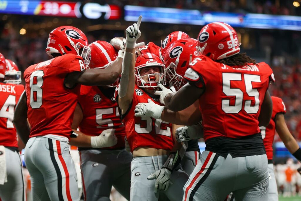 Georgia running back Cash Jones (32) celebrates with teammates after a touchdown against Clemson during the third quarter at Mercedes-Benz Stadium.