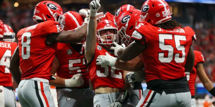 Georgia running back Cash Jones (32) celebrates with teammates after a touchdown against Clemson during the third quarter at Mercedes-Benz Stadium.