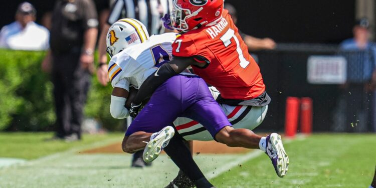 Daniel Harris (7) tackles Tennessee Tech wide receiver Jay Parker (4) at Sanford Stadium on September 7, 2024.