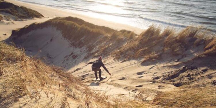 Go for sandboarding in White Sands, New Mexico, USA