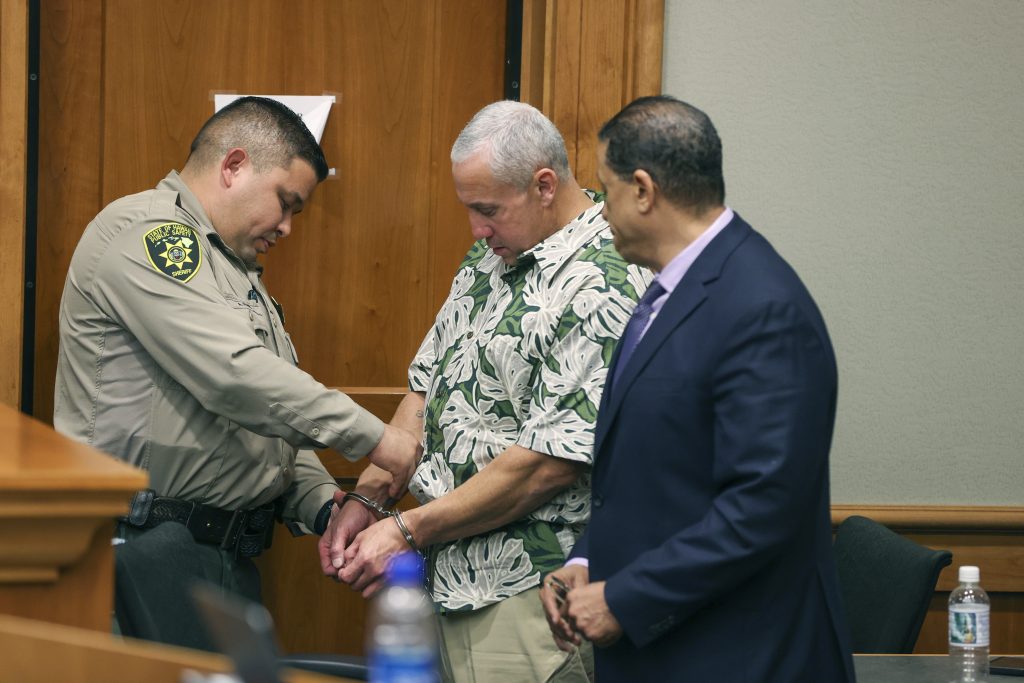 A court officer removes Albert 