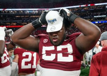 Dec 2, 2023; Atlanta, GA, USA; Alabama Crimson Tide offensive lineman Tyler Booker (52) dons an SEC Championship cap at Mercedes-Benz Stadium. Alabama defeated Georgia 27-24 to claim the SEC Championship. Mandatory Credit: Gary Cosby Jr.-USA TODAY Sports