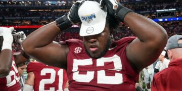 Dec 2, 2023; Atlanta, GA, USA; Alabama Crimson Tide offensive lineman Tyler Booker (52) dons an SEC Championship cap at Mercedes-Benz Stadium. Alabama defeated Georgia 27-24 to claim the SEC Championship. Mandatory Credit: Gary Cosby Jr.-USA TODAY Sports