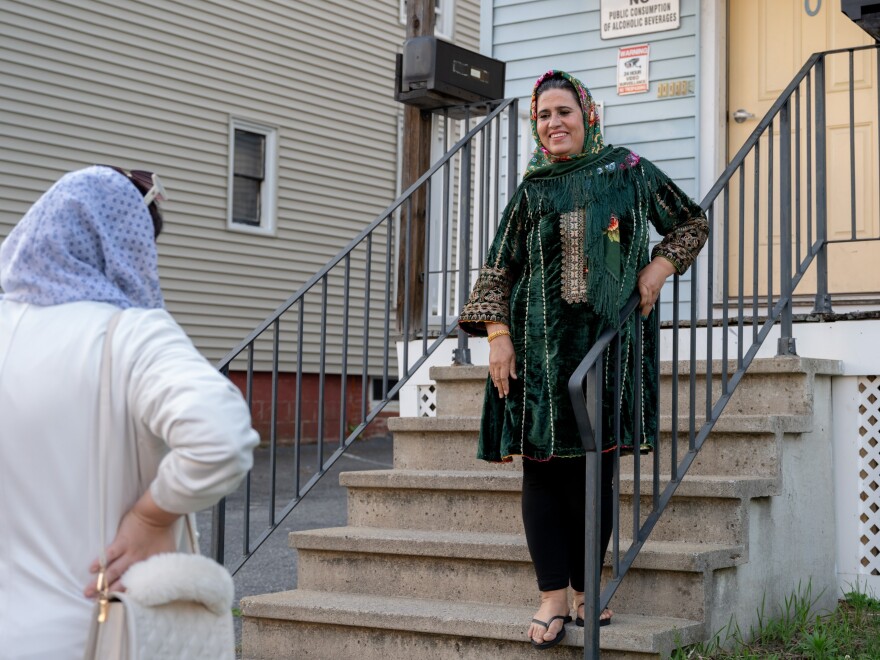 Khadija Rahmani speaks with health educator Shabana Siddiqui, left, as she leaves the Rahmani’s new home in Lewiston, Maine.