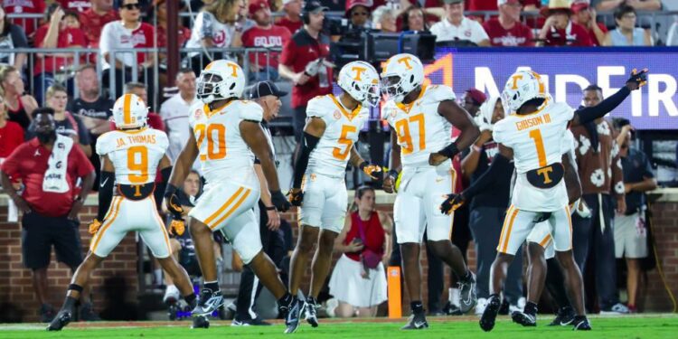 Sep 21, 2024; Norman, Oklahoma, USA; Tennessee Volunteers defensive lineman Bryson Eason (20) and Tennessee Volunteers defensive back Christian Harrison (5) and Tennessee Volunteers defensive lineman Jayson Jenkins (97) celebrates with teammates after a safety against the Oklahoma Sooners during the second quarter at Gaylord Family-Oklahoma Memorial Stadium. Mandatory Credit: Kevin Jairaj-Imagn Images