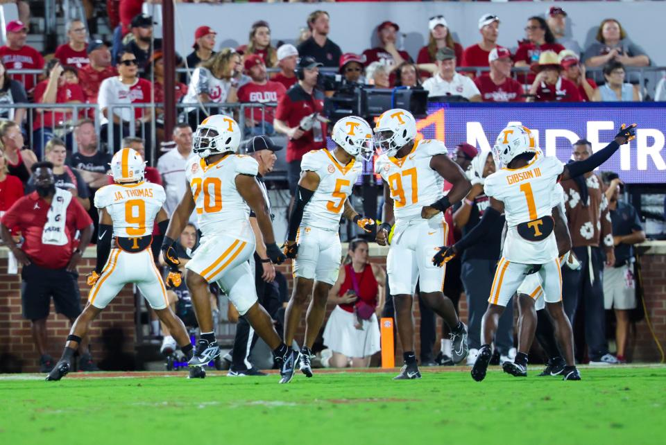 Sep 21, 2024; Norman, Oklahoma, USA; Tennessee Volunteers defensive lineman Bryson Eason (20) and Tennessee Volunteers defensive back Christian Harrison (5) and Tennessee Volunteers defensive lineman Jayson Jenkins (97) celebrates with teammates after a safety against the Oklahoma Sooners during the second quarter at Gaylord Family-Oklahoma Memorial Stadium. Mandatory Credit: Kevin Jairaj-Imagn Images