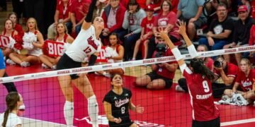 Oct 21, 2023; Lincoln, NE, USA; Nebraska Cornhuskers outside hitter Merritt Beason (13) attacks against Wisconsin Badgers middle blocker Caroline Crawford (9) during the fifth set at the Bob Devaney Sports Center. Mandatory Credit: Dylan Widger-USA TODAY Sports