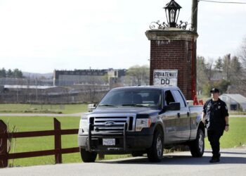 A police officer guards an entrance