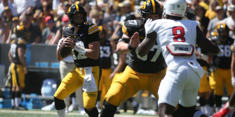 Iowa’s Cade McNamara (12) looks to throw against Illinois State