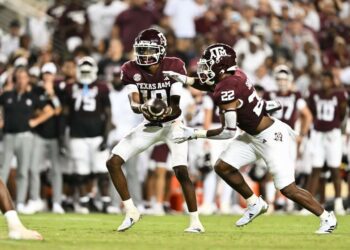 Sep 21, 2024; College Station, Texas, USA; Texas A&M Aggies quarterback Marcel Reed (10) hands off the ball to running back EJ Smith (22) during the fourth quarter at Kyle Field. Mandatory Credit: Maria Lysaker-Imagn Images.