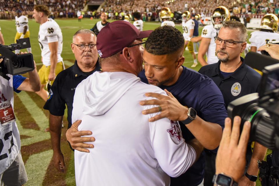 COLLEGE STATION, TEXAS - AUGUST 31: Head coach Marcus Freeman of the Notre Dame Fighting Irish and head coach Mike Elko of the Texas A&M Aggies embrace after the game at Kyle Field on August 31, 2024 in College Station, Texas. (Photo by Jack Gorman/Getty Images)