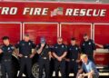 Maya with the firefighters who helped save her and her family.