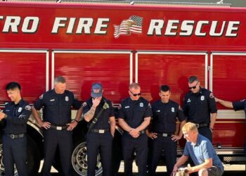 Maya with the firefighters who helped save her and her family.