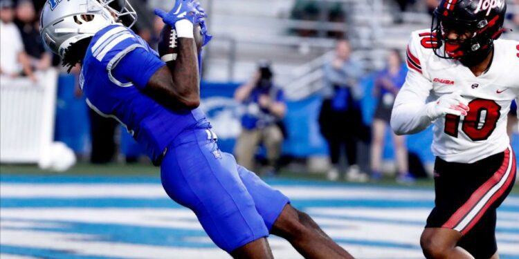 Middle Tennessee wide receiver Omari Kelly (1) catches a pass as Western Kentucky defensive back Jaymar Mundy (10) looks on during the rivalry football game at MTSU, on Saturday, Sept. 14, 2024.