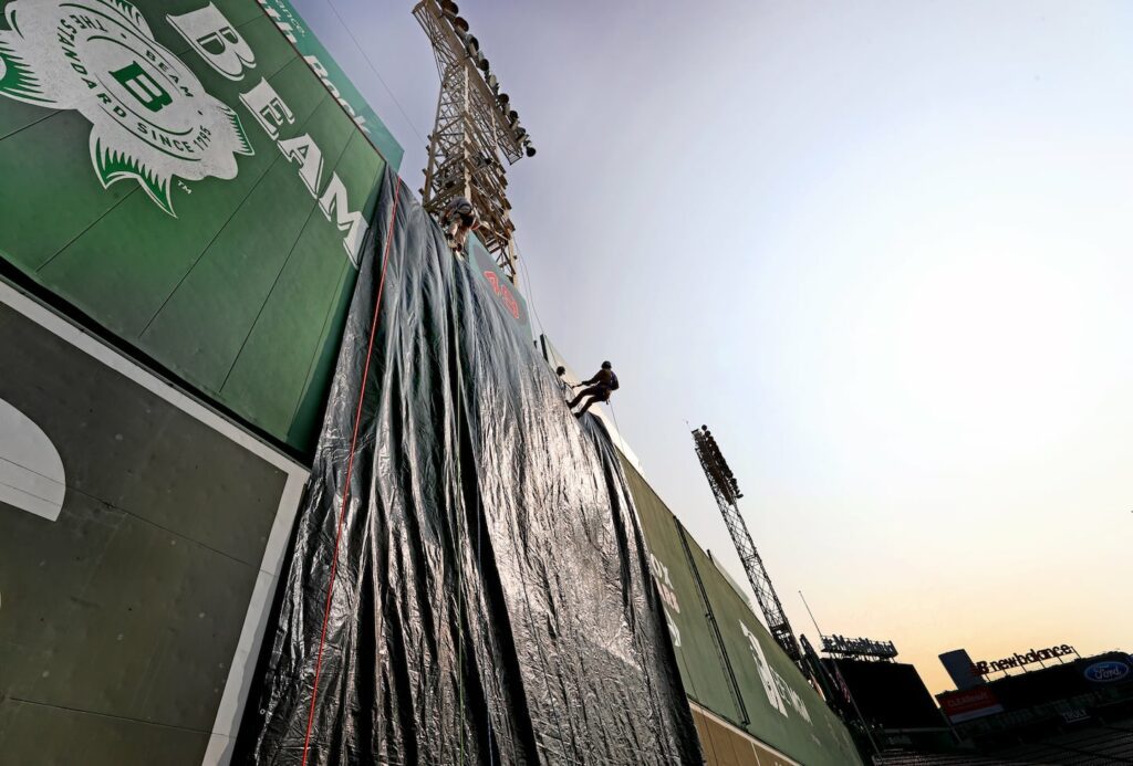 A tarp covered the Green Monster as firefighters rappelled during the joint training event.