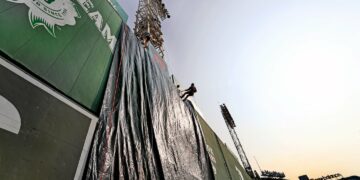 A tarp covered the Green Monster as firefighters rappelled during the joint training event.