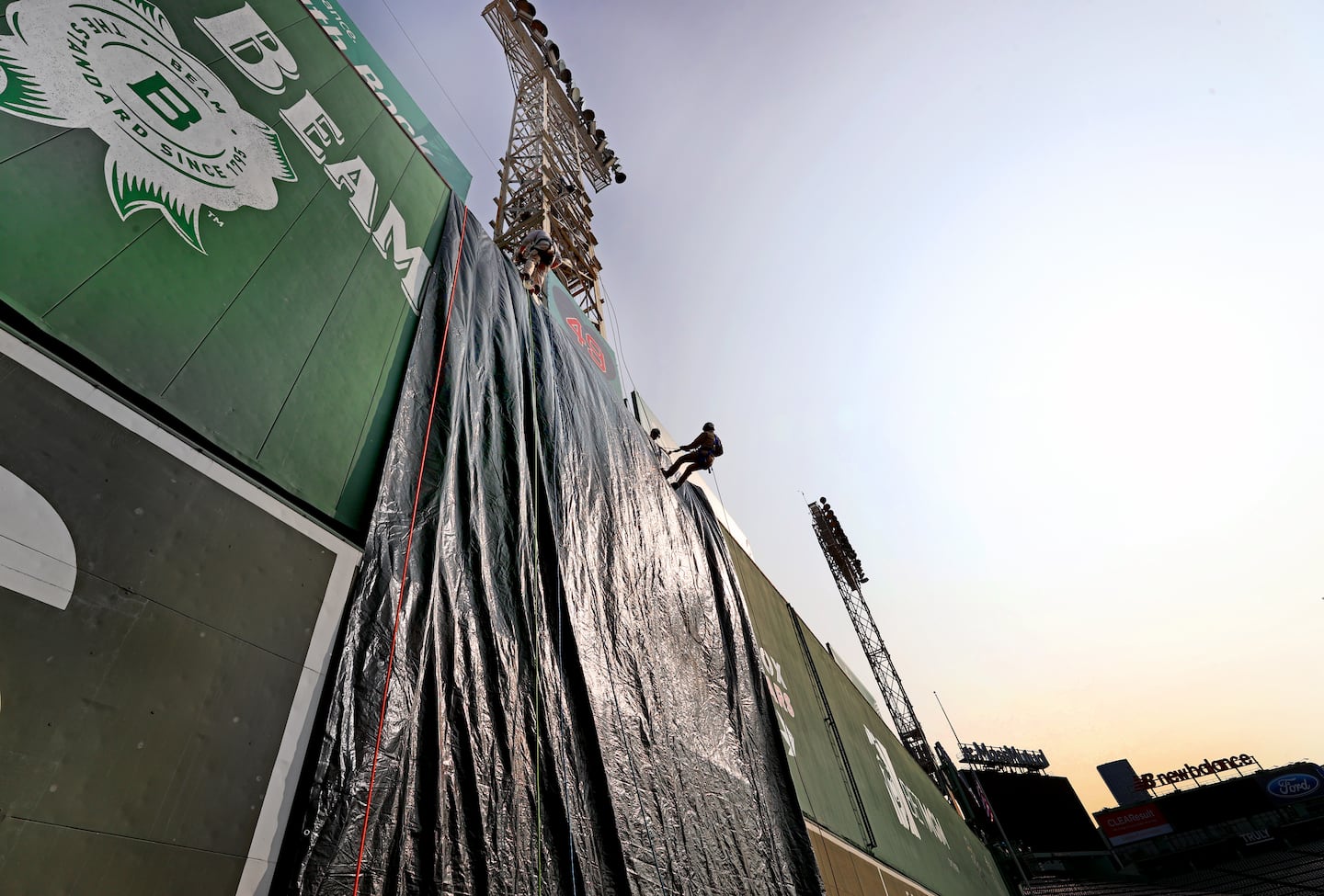 A tarp covered the Green Monster as firefighters rappelled during the joint training event.  