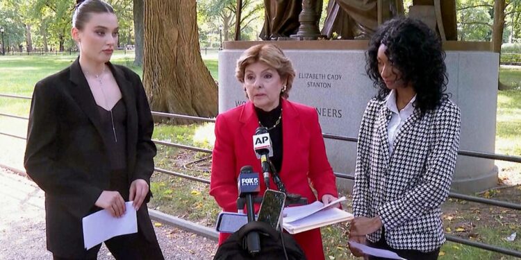 Flanked by Veronika Didusenko, left, and Danielle Hazel, right, attorney Gloria Allred, center, speaks during a news conference on September 16, 2024, in New York.