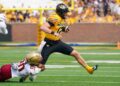 Sep 14, 2024; Columbia, Missouri, USA; Missouri Tigers quarterback Brady Cook (12) runs the ball as Boston College Eagles defensive back KP Price (20) makes the tackle during the first half at Faurot Field at Memorial Stadium. Mandatory Credit: Denny Medley-Imagn Images