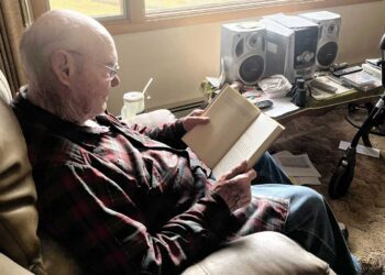 Robert Boettcher reads from his home in Big Sandy.