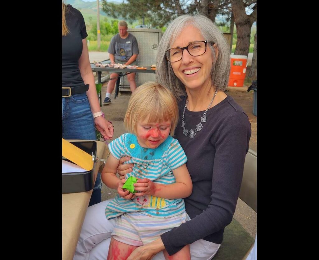 Beth Braithwaite with granddaughter Annabelle at a fundraiser to assist with resettlement of a family of South American refugees to Utah. Braithwaite is part of the Morgan County group that spearheaded the resettlement effort.