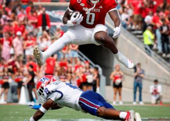 N.C. State running back Kendrick Raphael (0) hurdles over Louisiana Tech defensive back Demarcus Griffin-Taylor (8) during the first half of N.C. State’s game against LA Tech at Carter-Finley Stadium in Raleigh, N.C., Saturday, Sept. 14, 2024.