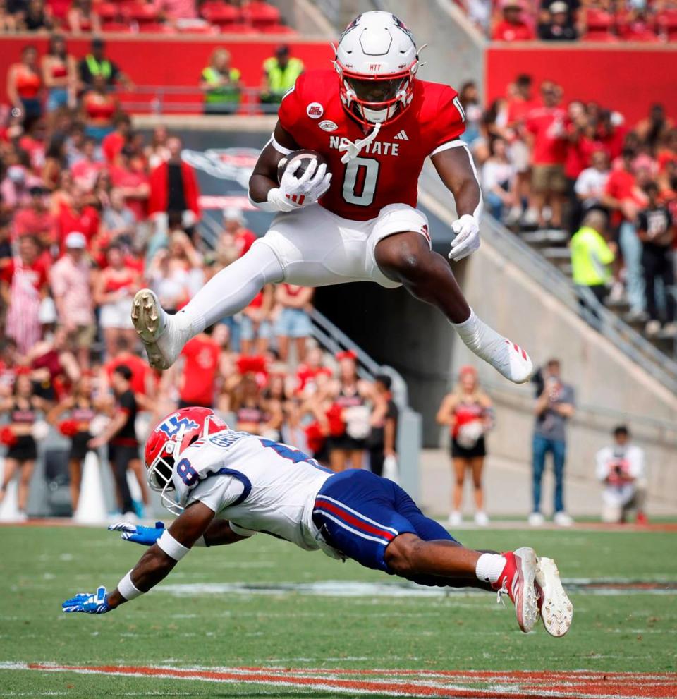 N.C. State running back Kendrick Raphael (0) hurdles over Louisiana Tech defensive back Demarcus Griffin-Taylor (8) during the first half of N.C. State’s game against LA Tech at Carter-Finley Stadium in Raleigh, N.C., Saturday, Sept. 14, 2024.