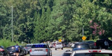 Parents cars line the sides of the road near Apalachee High School in Winder, Georgia after a shooting occurred at the school on Wednesday, Sept. 4, 2024.