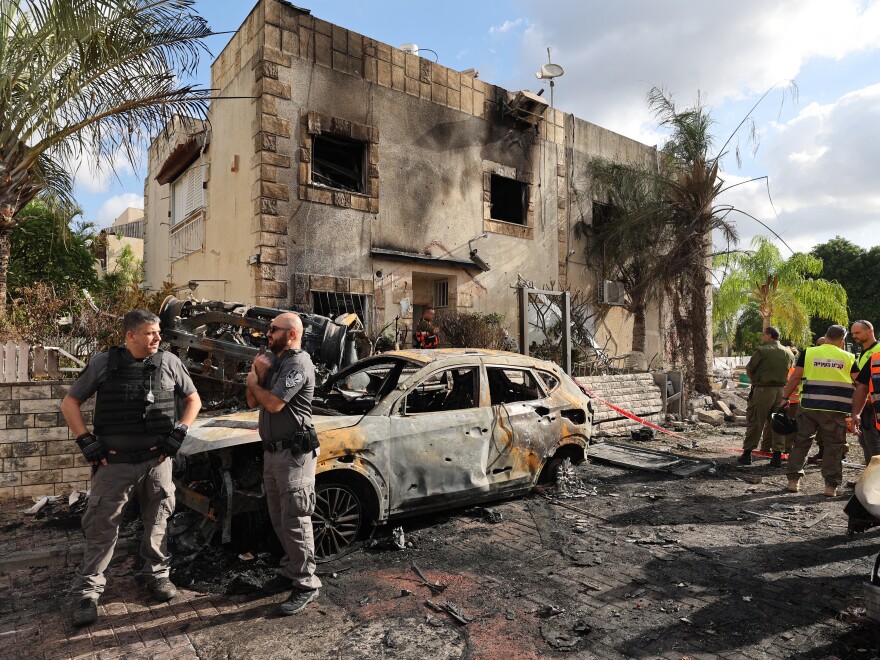 A man looks at the site hit by a rocket fired from Lebanon, in Kiryat Bialik, northern Israel, on Sunday.