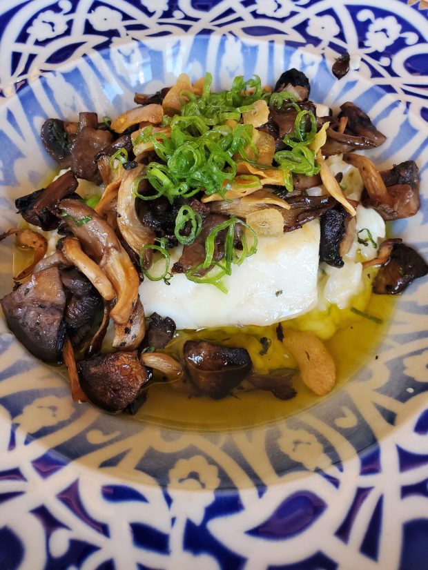 A lunch offering from Comedor Nishi features fish, mushrooms and garlic rice. (Ashley Mackin-Solomon)