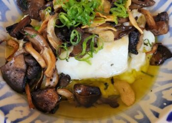 A lunch offering from Comedor Nishi features fish, mushrooms and garlic rice. (Ashley Mackin-Solomon)