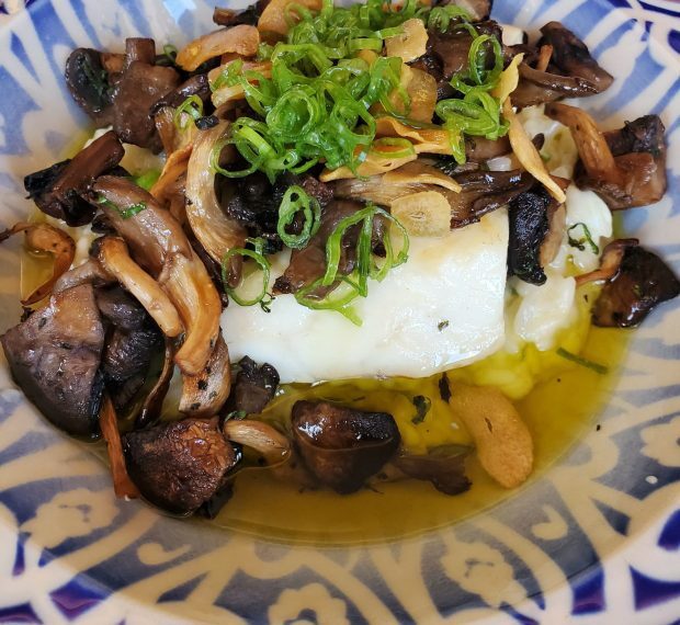 A lunch offering from Comedor Nishi features fish, mushrooms and garlic rice. (Ashley Mackin-Solomon)