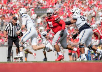 Aug 31, 2024; Columbus, OH, USA; Ohio State Buckeyes defensive tackle Tyleik Williams (91) pursues Akron Zips quarterback Ben Finley (10) during the NCAA football game at Ohio Stadium. Ohio State won 52-6.