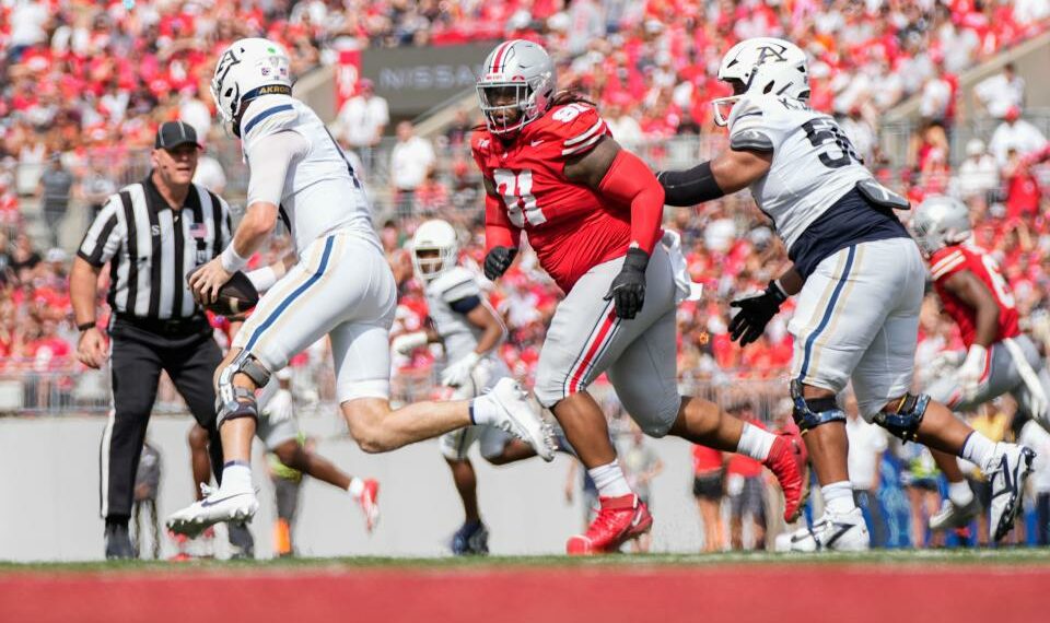 Aug 31, 2024; Columbus, OH, USA; Ohio State Buckeyes defensive tackle Tyleik Williams (91) pursues Akron Zips quarterback Ben Finley (10) during the NCAA football game at Ohio Stadium. Ohio State won 52-6.