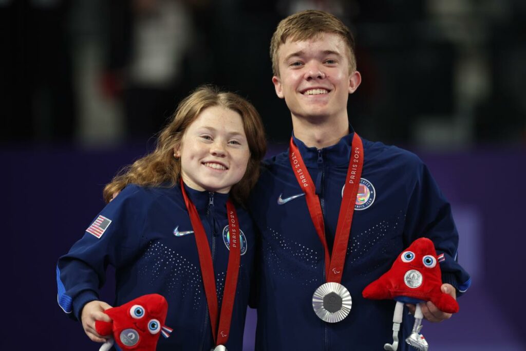 Silver medalists, Jayci Simon (left) and Miles Krajewski of Team USA, pose for a photo during the mixed doubles SH6 final medal ceremony on Day 5 of the Paralympics .