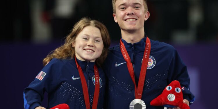 Silver medalists, Jayci Simon (left) and Miles Krajewski of Team USA, pose for a photo during the mixed doubles SH6 final medal ceremony on Day 5 of the Paralympics .