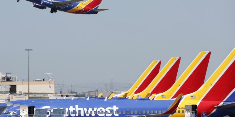 A Southwest Airlines plane takes off from Hollywood Burbank Airport as other Southwest planes are parked at their gates on July 25, 2024 in Burbank, California.