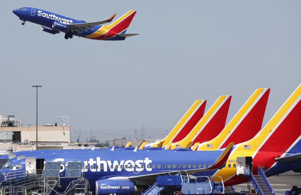 A Southwest Airlines plane takes off from Hollywood Burbank Airport as other Southwest planes are parked at their gates on July 25, 2024 in Burbank, California.