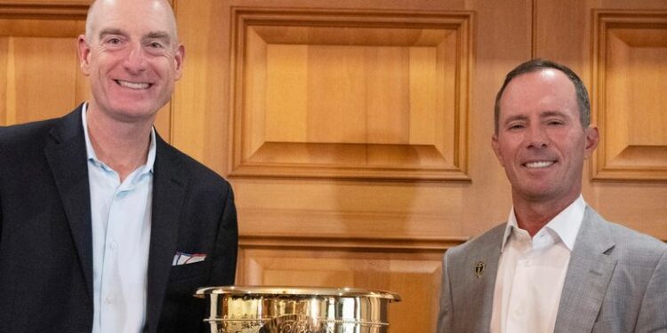 2024 Presidents Cup captains Mike Weir, right, for the international team, and Jim Furyk, for the U.S. team, pose for photos Tuesday, Sept. 12, 2023, at Royal Montreal Golf Club in Ile-Bizard, Quebec. (Ryan Remiorz/The Canadian Press via AP)