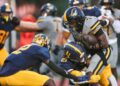 American Heritage Patriots running back Byron Louis (7) is tackled by Naples Golden Eagles linebacker Khari Bendolph (21) during the first quarter of a game at Staver Field in Naples on Friday, Sept. 13, 2024.