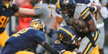 American Heritage Patriots running back Byron Louis (7) is tackled by Naples Golden Eagles linebacker Khari Bendolph (21) during the first quarter of a game at Staver Field in Naples on Friday, Sept. 13, 2024.