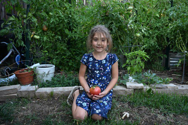 Naomi, 7, shows off the family's prized garden that is full of vegetables at her home in Denver on Sept. 17, 2024. (Photo by Helen H. Richardson/The Denver Post)