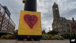 An image of a broken heart is fixed across the street from City Hall with the Heritage Center of Clark County, right, Sept. 17, 2024, in Springfield, Ohio.