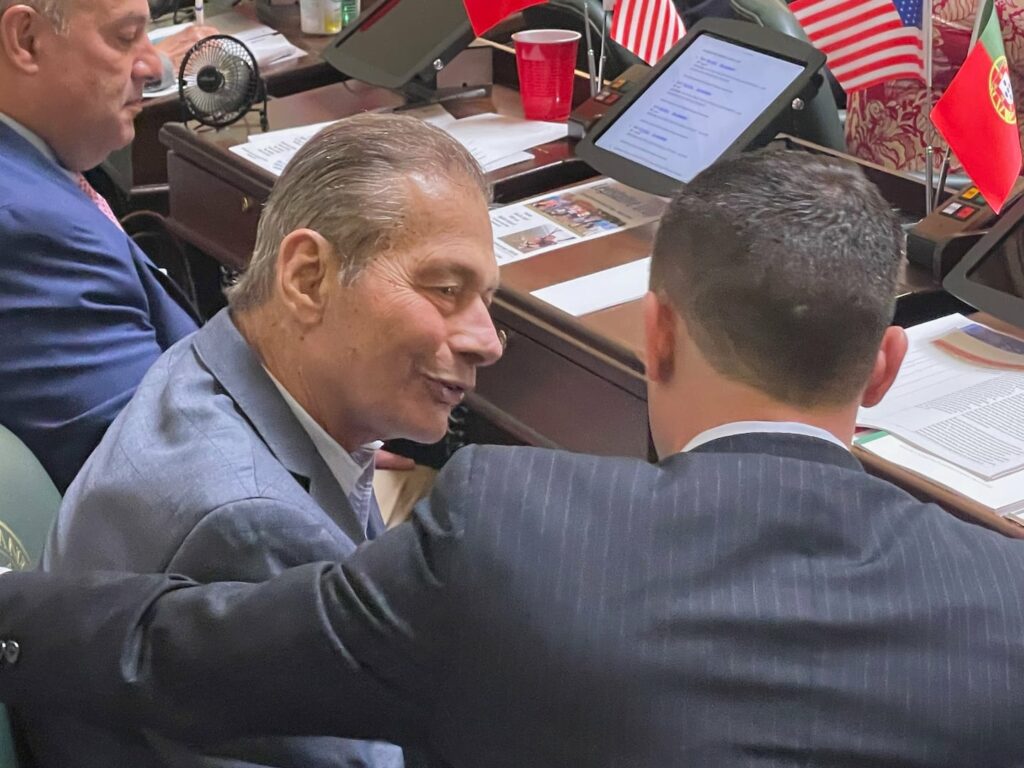 Rhode Island Senate President Dominick J. Ruggerio, left, speaks with Senator Jake Bissaillon prior to a Senate session earlier this year.